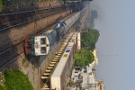An approaching train viewed from overbridge