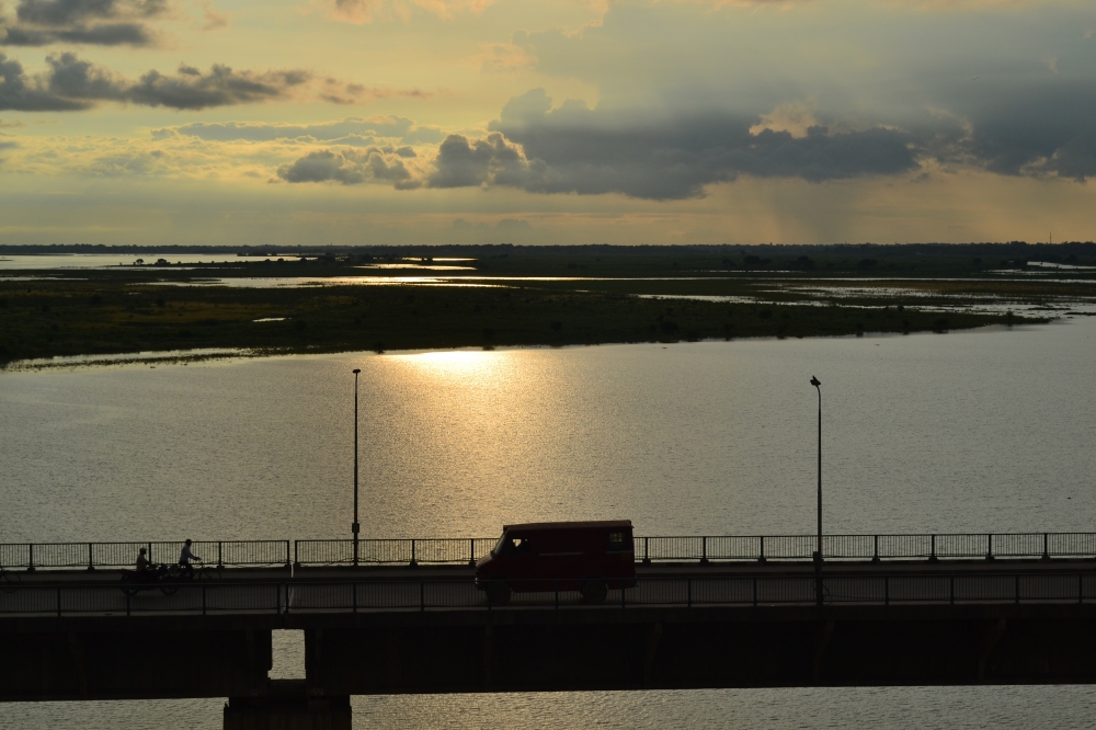Sunset over river Ganges, River, bridge, setting sun, traffic, beautiful