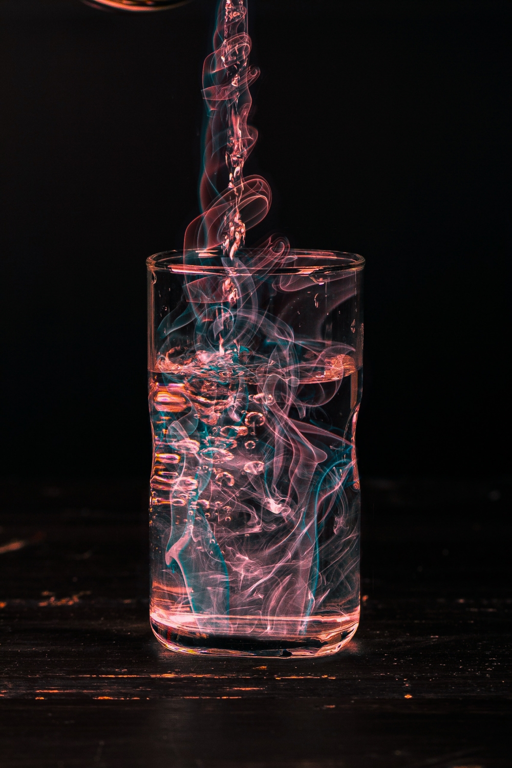 Poluted water pouring in glass, glass