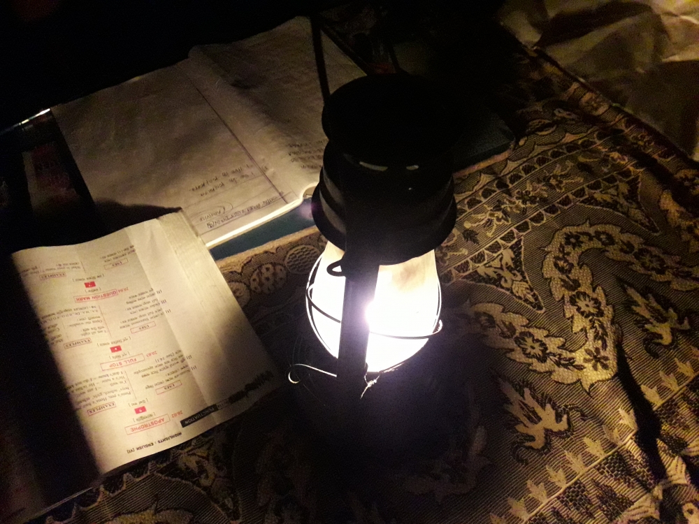 READING WITH A LANTERN , Lantern is lighted with kerosene oil and a cotton tape.