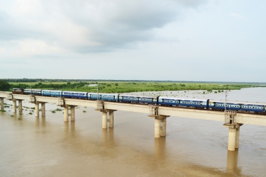 A train crossing a river bridge